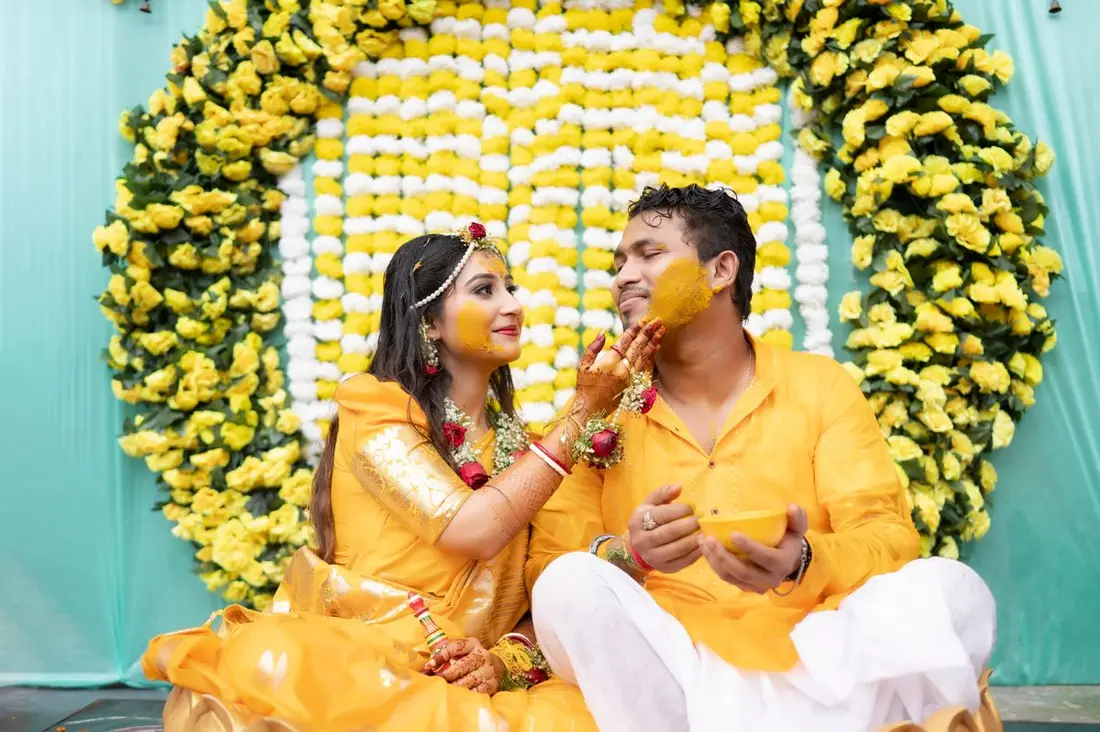 Family laughter and turmeric at the haldi function