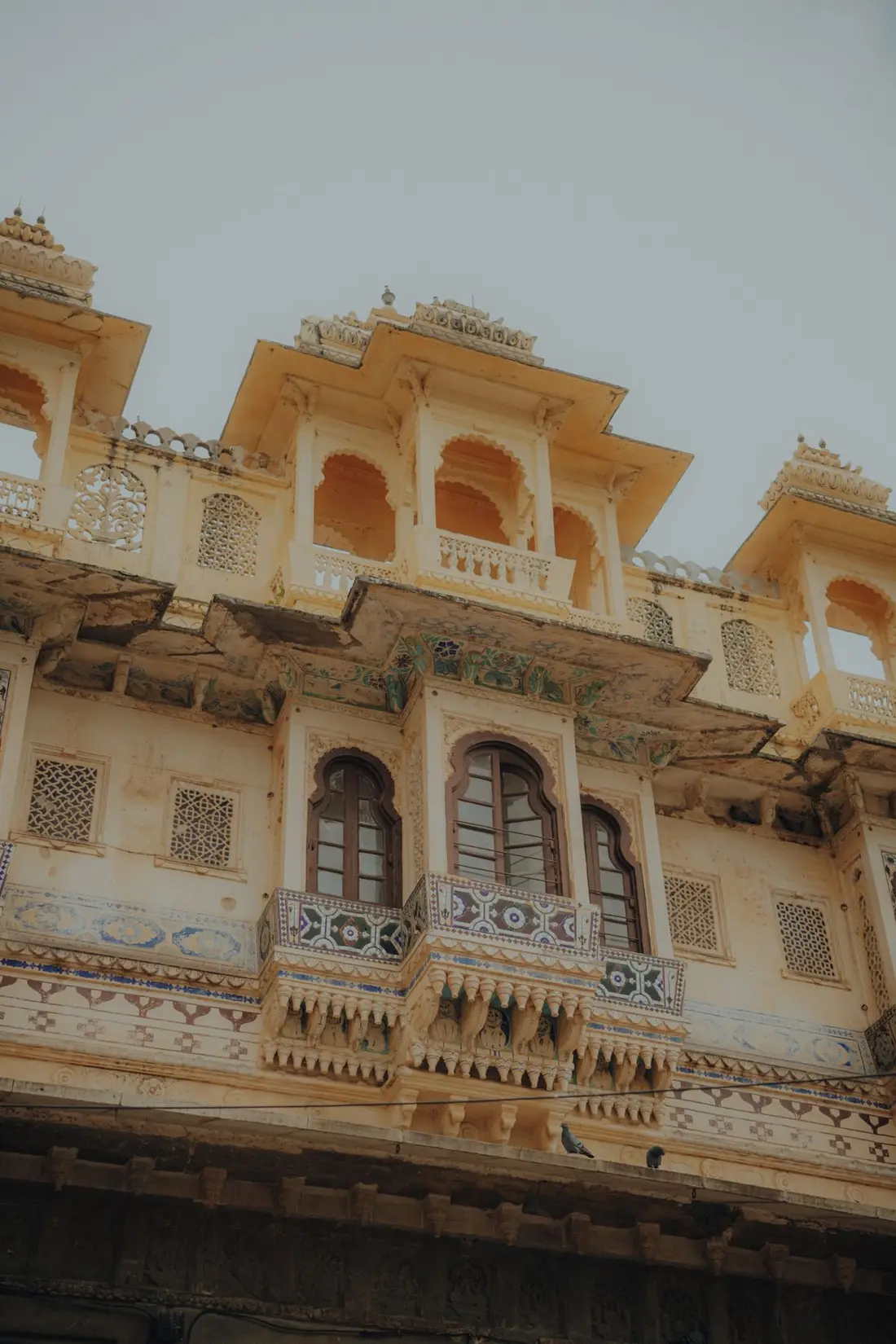 Sandstone domes and turrets of a Rajasthan palace under a clear sky